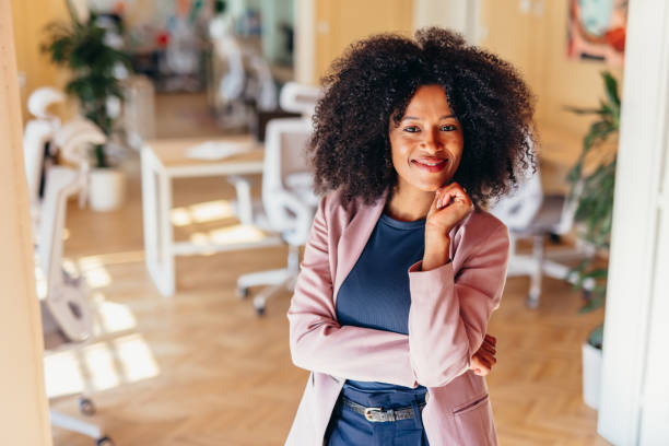 istock Confident businesswoman smiling in modern office space 2198589754