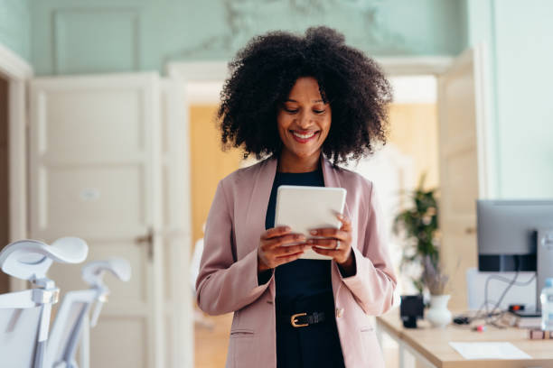 istock Smiling businesswoman using digital tablet in modern office 2198589817
