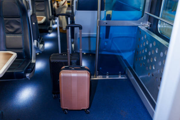 istock Two Suitcases Waiting in a Train Carriage for Passengers to Arrive 2198590006