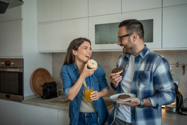 istock Doughnut lovers - A couple’s sweet kitchen moment 2198590553