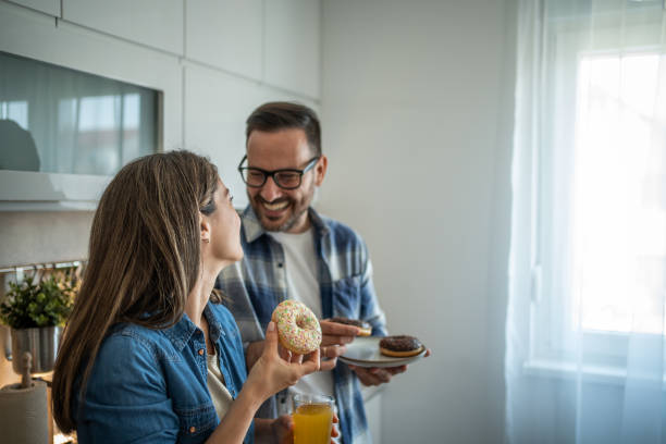 istock Doughnut lovers - A couple’s sweet kitchen moment 2198590576