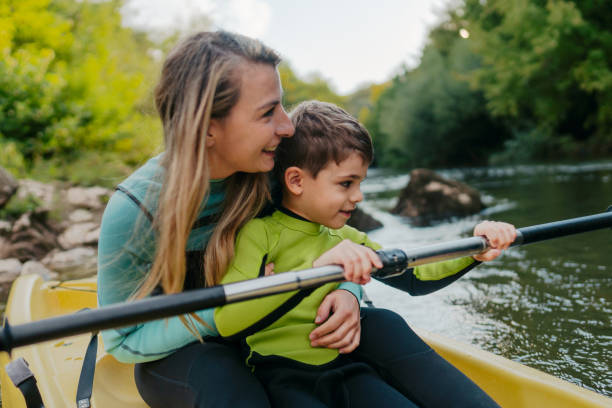 istock Mother and son kayaking on the river 2198590594