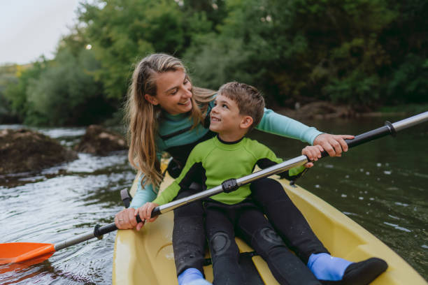 istock Mother and son kayaking on the river 2198590737