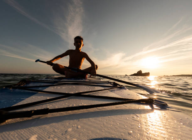 Teen boy on paddle board