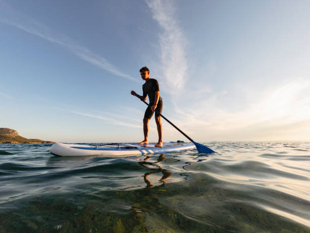 istock Young man driving stand up paddle board at the sea 2198591009
