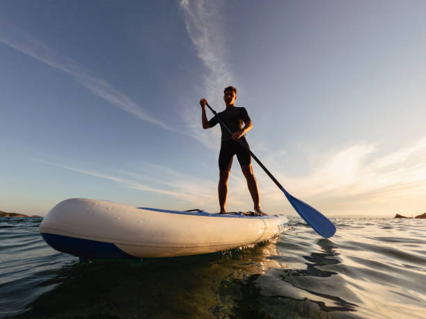 istock Young man driving stand up paddle board at the sea 2198591010