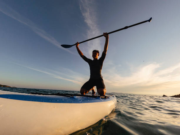 istock Young man driving stand up paddle board at the sea 2198591531