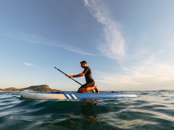 istock Young man driving stand up paddle board at the sea 2198591533
