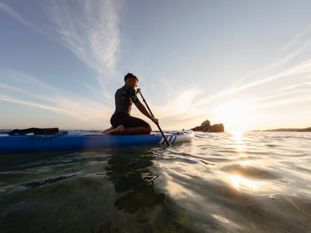 istock Young man driving stand up paddle board at the sea 2198591552