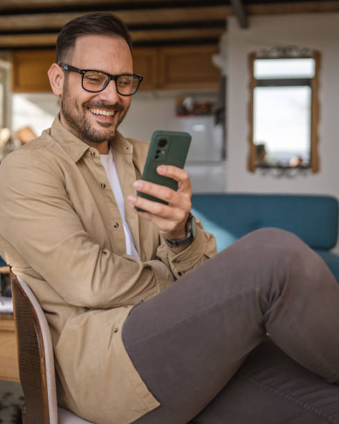 istock One adult man at home use smart phone app browse internet or send sms 2198593184