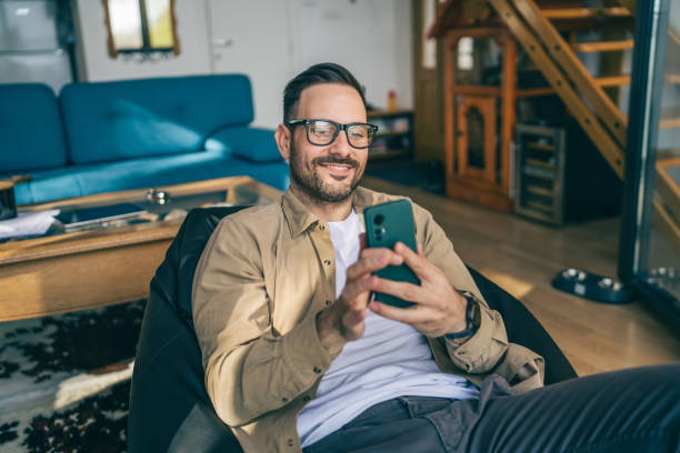 istock One adult man at home use smart phone app browse internet or send sms 2198593206