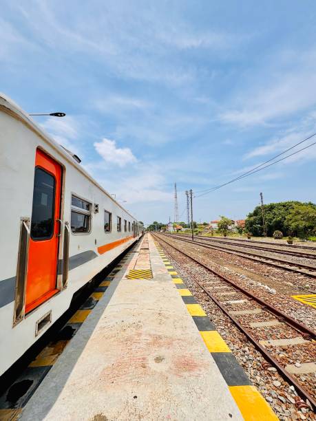 istock Train at Railway Station with Clear Blue Sky 2198593230