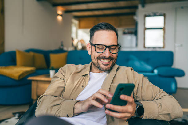 istock One adult man at home use smart phone app browse internet or send sms 2198593317