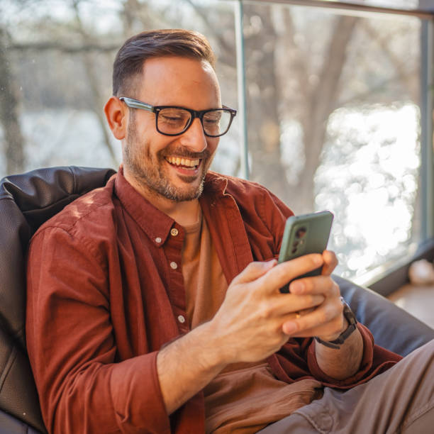 istock One adult man at home use smart phone app browse internet or send sms 2198593559