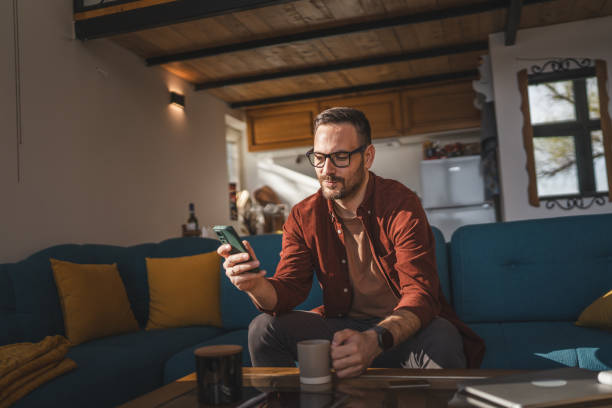 istock One adult man at home use smart phone app browse internet or send sms 2198593635