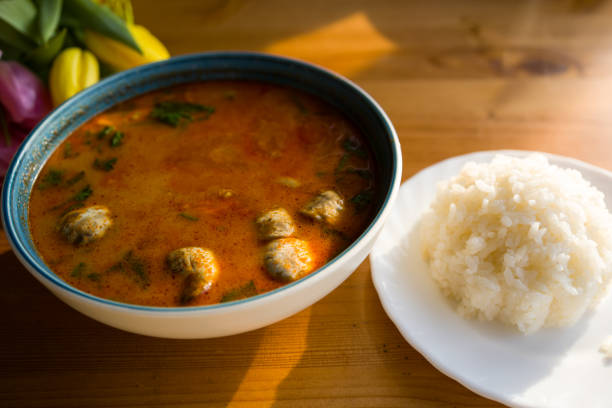 istock Tom yam restaurant soup in a bowl. Hot spicy dish with rice on the table 2198593668