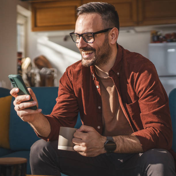 istock One adult man at home use smart phone app browse internet or send sms 2198593670