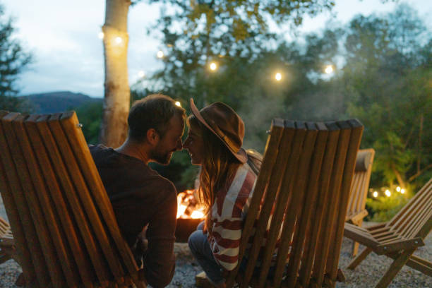 istock Romantic couple by the campfire 2198593926