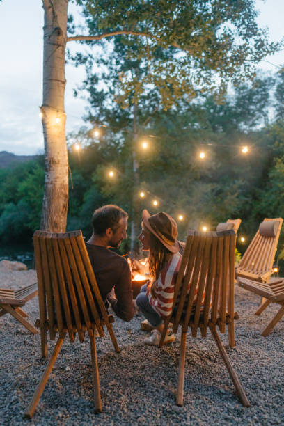 istock Romantic couple by the campfire 2198593947