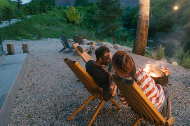 istock Romantic couple by the campfire 2198593990