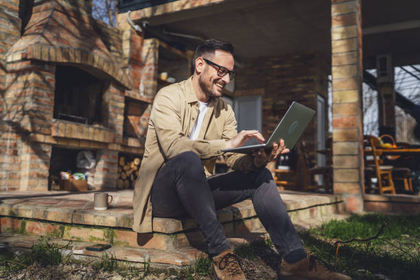 istock man caucasian work on laptop computer on terrace happy smile success 2198594721