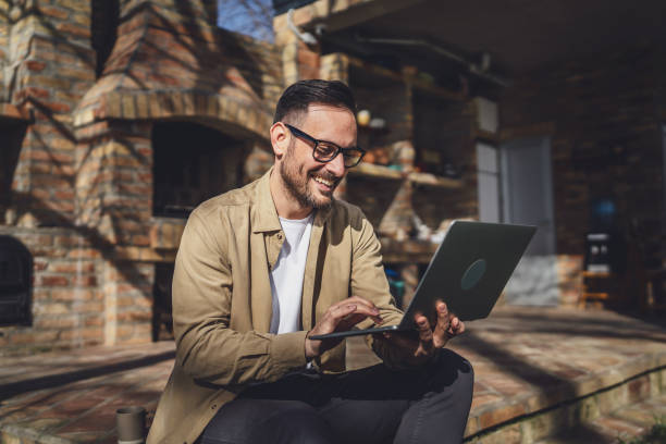 istock man caucasian work on laptop computer on terrace happy smile success 2198594768