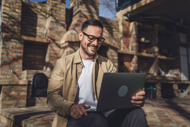 istock man caucasian work on laptop computer on terrace happy smile success 2198594987