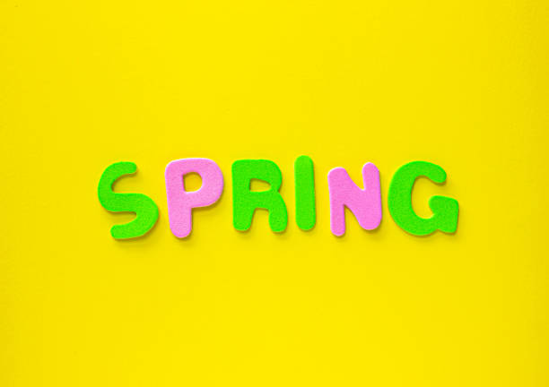 istock Colored letters spelling out spring on Yellow background with copy space. 2198596345