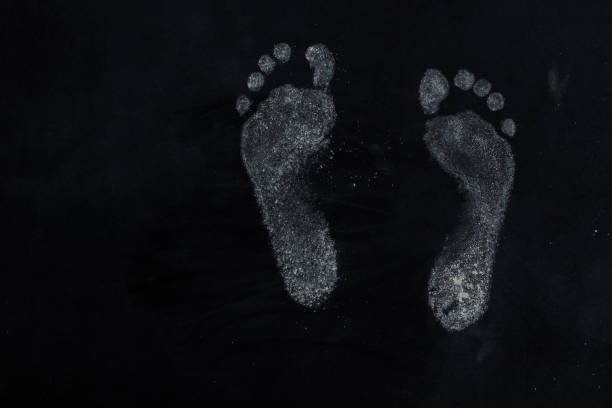 real dirt feet print on black background