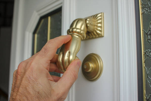 istock an adult hand in a door knocker 2198600361