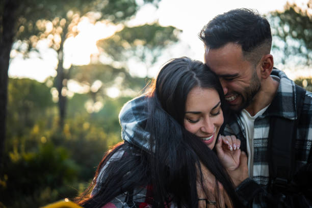 istock Young tourist couple hugging and smiling in a forest 2198601718