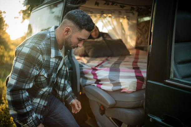 istock Young man getting into his camper van at sunset 2198601784