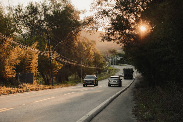 Valença, RJ, Brazil - August 29, 2024: Cars on the RJ-145 route at sunset.
