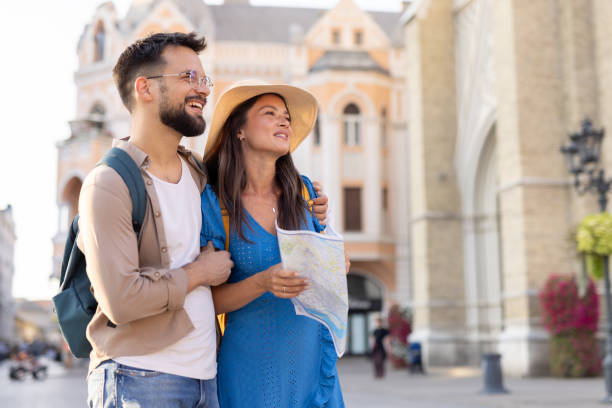 istock A happy couple exploring city streets with a map in hand. 2198601959