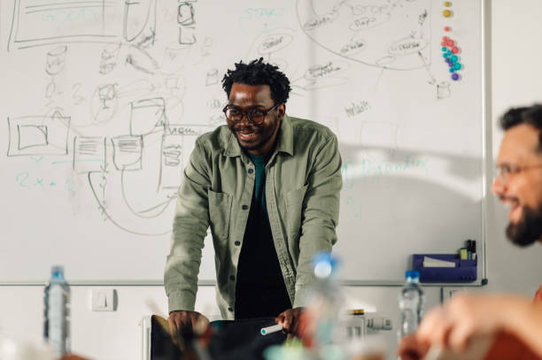 istock Smiling male project manager leading a brainstorming session 2198602241