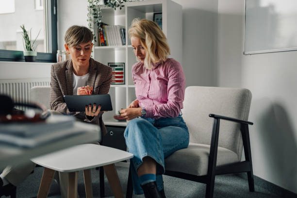 istock Two businesswomen using digital tablet during meeting in office 2198602251