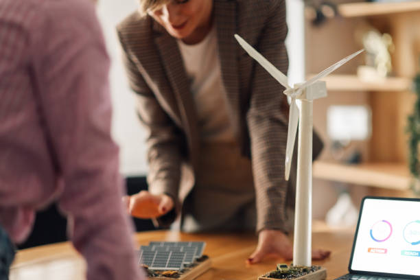 istock Engineers analyzing miniature wind turbine and solar panel for renewable energy project 2198602294