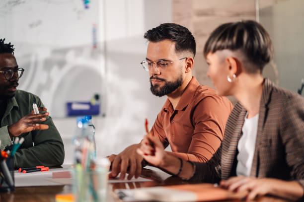 istock Business people collaborating on project during office meeting 2198602336