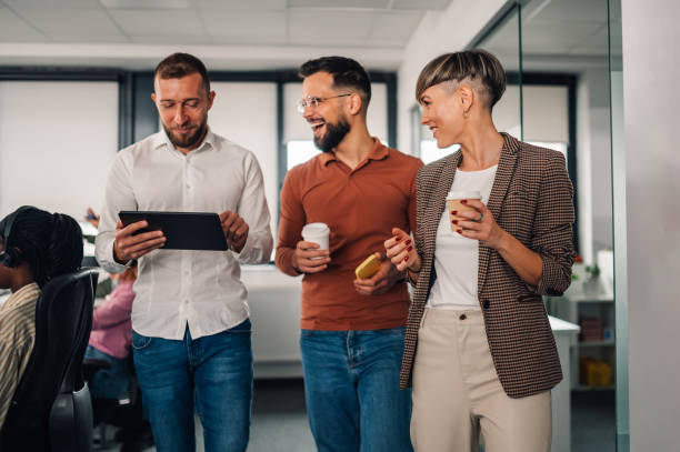 istock Business people walking and talking in office corridor 2198602350