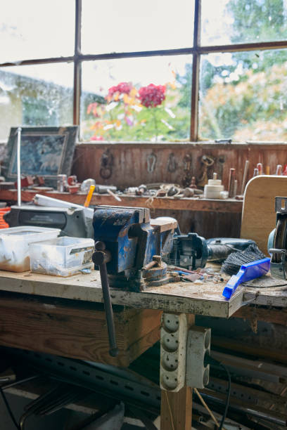 istock Rustic workshop table with old tools and a vise near a window. From my late great-grandfather's workshop. 2198602840