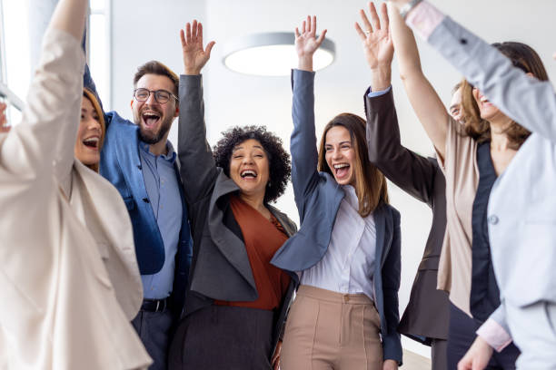 istock Group of professionals expressing excitement in office 2198603053