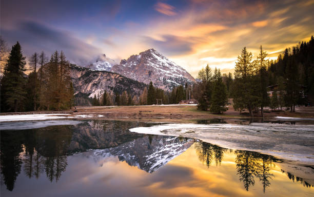 istock Breathtaking sunset reflected in serene lake surrounded by Dolomites mountains 2198603297