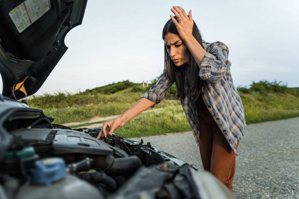 istock Woman having car problems and looking under the hood 2198603954