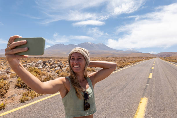 istock Woman Taking Selfie on Deserted Mountain Road 2198604714