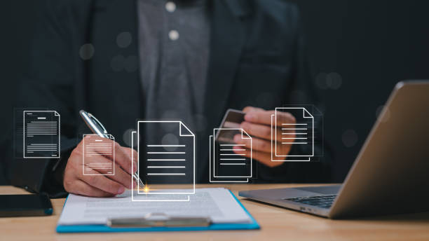 istock Digital Documentation The Future of Professional Work, Professional engages with digital documents while writing on paper, blend of traditional and modern workflows in todays business environment 2198604786