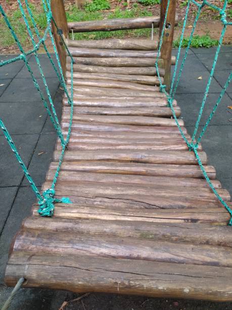 istock A wooden log bridge designed as a playground structure for children. 2198605197