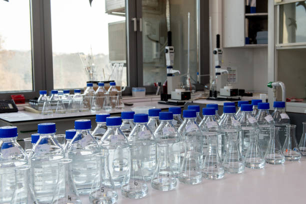 istock Laboratory equipment. Laboratory storage bottles with blue polypropylene cap on white table. 2198612948