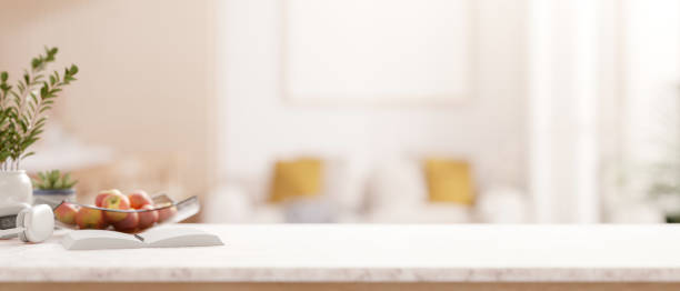 istock A luxury white tabletop with decorative items over a blurred background of a modern living room. 2198616511