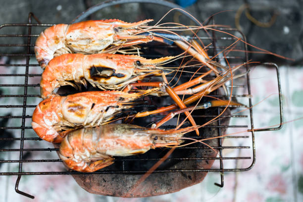 istock Fresh river prawns grilled over charcoal fire. 2198617688