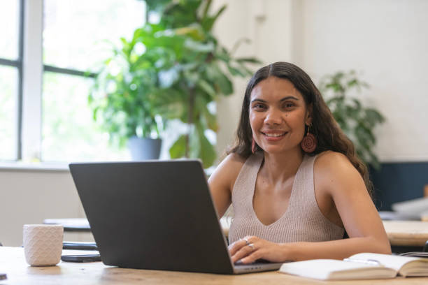 istock Australian aboriginal woman working at a laptop computer in a modern office 2198619692